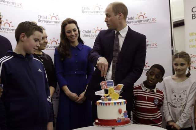 The Duke and Duchess of Cambridge cut a cake to celebrate the one year anniversary of the  charity's branch, during a visit to Child Bereavement UK's centre in Stratford, east London