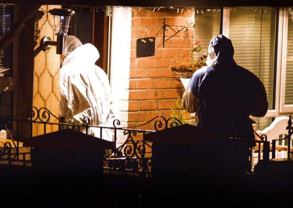 Forensic officers at the scene of the shooting in west Belfast on Thursday evening.

 Photo: Pacemaker Press