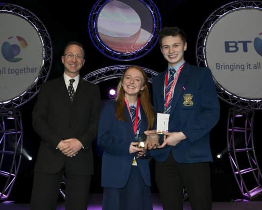 David Hughes, DENI, presents the BT NI Best Project Award to Sian Donaghy and Donal Close from Loreto College, Coleraine