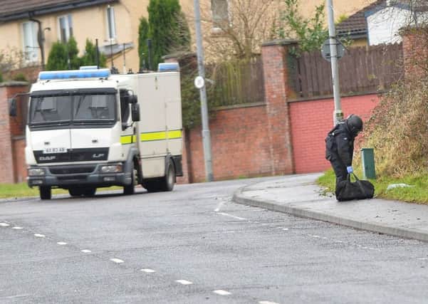Police and ATO  at the scene of a security alert in the Brians Well Road area of west Belfast on Sunday morning.
