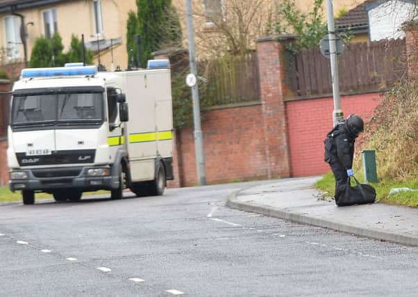 Police and ATO  at the scene of a security alert in the Brians Well Road area of west Belfast on Sunday morning