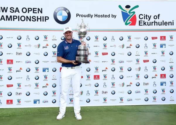 Graeme Storm poses with the trophy after his play-off win in the final round of the 2017 BMW South African Open Championship at Glendower Golf Club.  (Photo by David Cannon/Getty Images)
