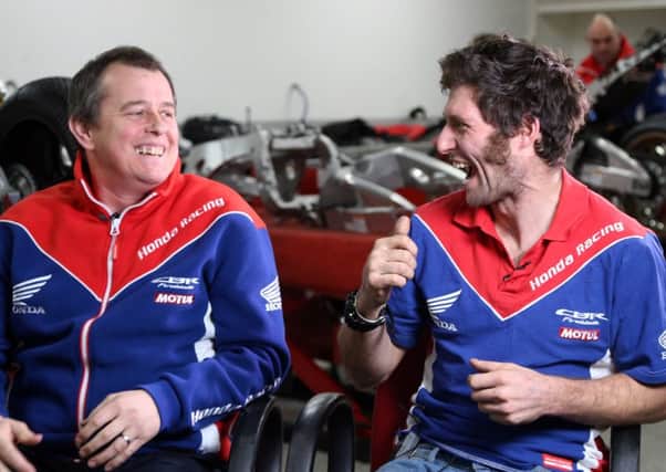 John McGuinness (left) shares a laugh with his new Honda Racing team-mate Guy Martin.
