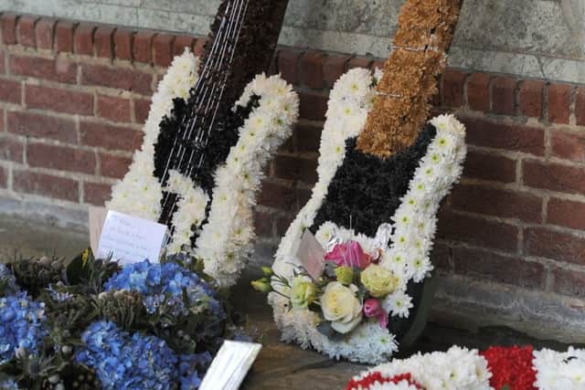 Floral tributes are left for Status Quo guitarist Rick Parfitt at Woking Crematorium during his funeral, after he died on Christmas Eve