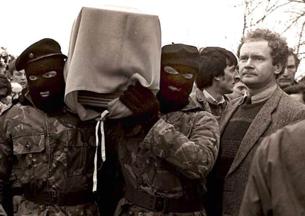 Martin McGuinness with masked IRA men at the funeral of Brendan Burns in 1988