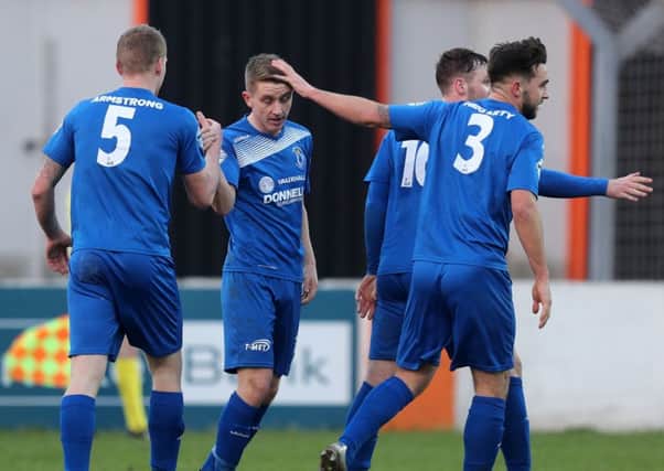 Dungannon Swifts Alan Teggart whose free kick was turned into his own  net by Carrick's Sam O'Connor, is congratulated by his team mates