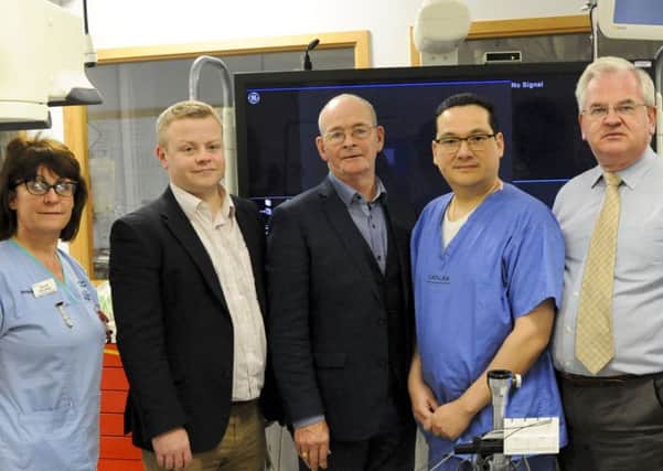 Mr Donie Cronin (Centre) with clinical personnel (left to right) Bernie McCallan, Dr Aaron Peace, Dr Godfrey Aleong and Dr Albert McNeill at Altnagelvin Hospital where the cross-border cardiology service has been credited with saving the lives of 27 patients from Co Donegal in its first nine months. PA