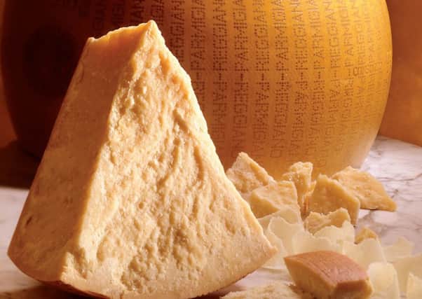 This image released by the Consorzio Parmigiano Reggiano shows a an aged form of original Parmesan cheese. In Italy, it takes at least a year to cure Parmigiano Reggiano to produce, the crumbly texture and the pungent _ some say downright smelly _ aroma of a fine Parmesan cheese. Parmesan's history dates to the Middle Ages, when monks in northern Italy developed the recipe. (AP Photo/Consorzio Parmigiano Reggiano)