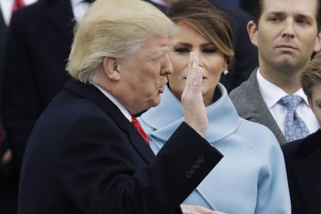 Donald Trump is sworn in as the 45th president of the United States by Chief Justice John Roberts as Melania Trump looks on during the 58th Presidential Inauguration at the U.S. Capitol in Washington, Friday, Jan. 20, 2017. (AP Photo/Patrick Semansky)