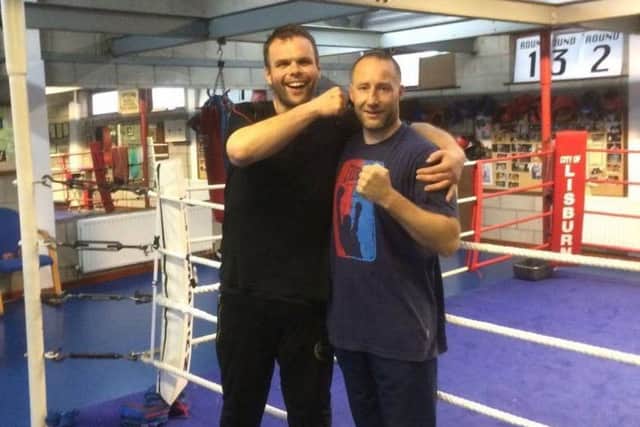 Stefan Ginesi (left) has undergone an incredible transformation. He is pictured with his boxing trainer Marty Laverty of Tonagh Boxing.