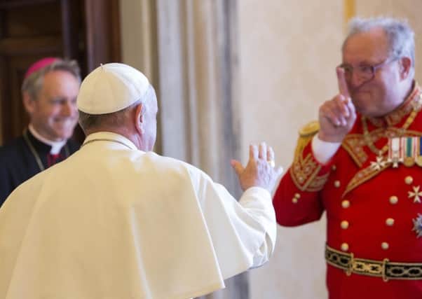 Pope Francis greets the Grand Master of the Sovereign Order of Malta, Matthew Festing, right, at the end of a private audience in the Pontiff's private library at the Vatican in June 2015.File)