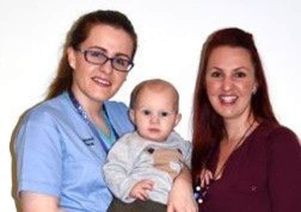 Award winning midwife Joanne Murray (left) with proud mother Hannah Magowan and her little boy Tom
