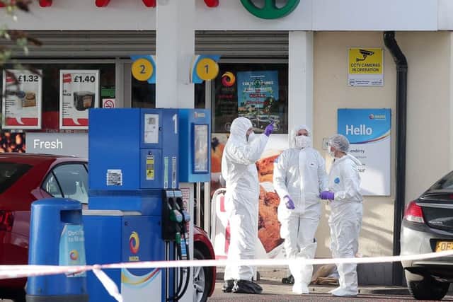January 23, 2017:

Forensic experts on the scene at a petrol station on the Crumlin Road in north Belfast where an on-duty PSNI officer was shot in the arm during a gun attack