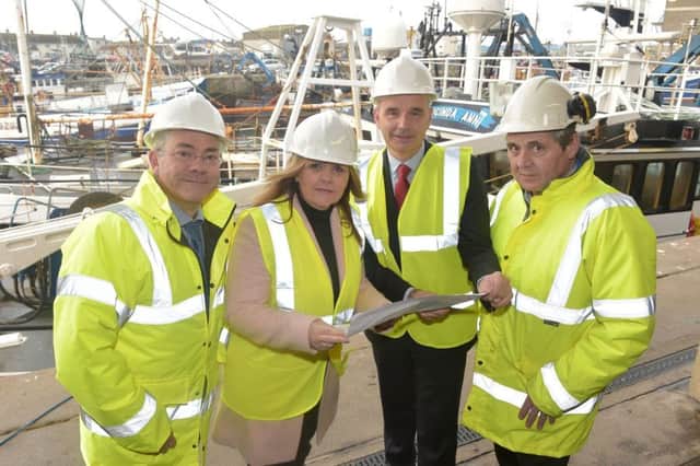 Fisheries Minister Michelle McIlveen views plans for the upgrade of Portavogie Fish Market with  David Lindsay Project Manager for NIFHA, Kevin Quigley, CEO NIFHA and Eddie Robinson, Portavogie Harbour Master. Photo by Simon Graham/Harrison Photography