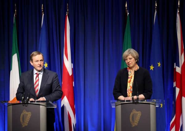 Taoiseach Enda Kenny TD and Prime Minister Theresa May during a press conference at Government Buildings in Dublin. Photo: Niall Carson/PA Wire