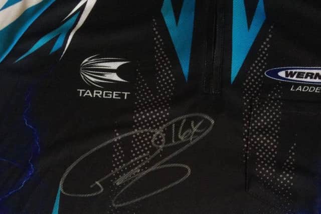 The signed shirt donated to the charity auction by 16-times world champion Phil The Power Taylor