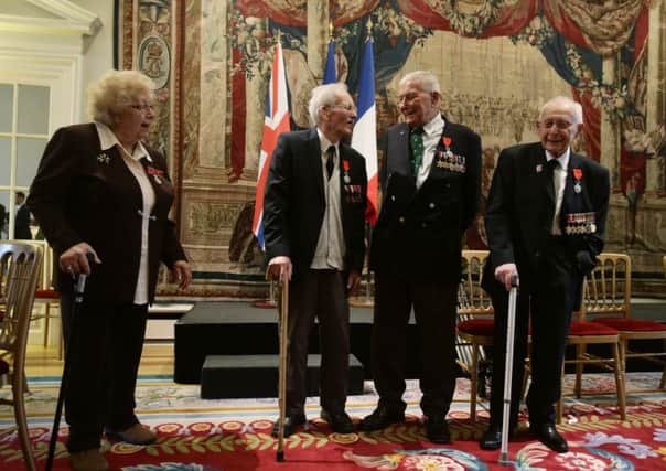 Alfred Arthur Wilson, 91, from Enfield, Stoker in the Royal Marine , John Alfred Duke, 95, from Surrey, Corporal in the Royal Armoured Corps and, Schera Morris Masters, 97, from Essex , Lance Corporal as Alfred's wife Irene looks on