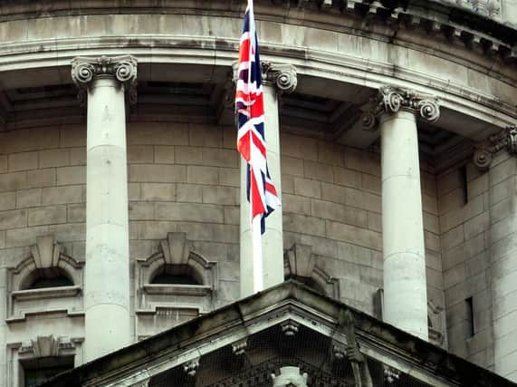File photo dated 09/01/13 of the Union flag flying over Belfast City Hall. A resident of the city has won a case at the UK's highest court over the failure of Northern Ireland police to prevent union flag protests.