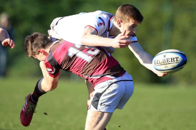 RS Dungannon's Aaron McCammon tackles his RS Armagh opposite number during their Schools' Cup game.