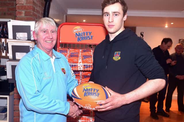 Ballymena's, Sean McCormick accepts the man of the match award from tournament committee member Sid Rowe