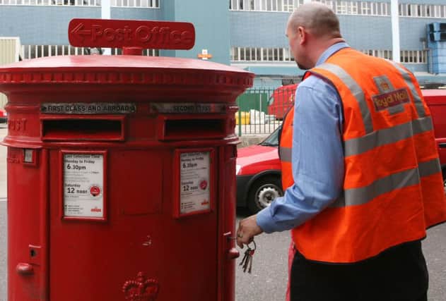 File photo dated 28/07/2009 of a postal worker emptying a post box in London, as Royal Mail was dealt a fresh blow after regulator Ofcom said it would not impose new conditions on the firm's direct-delivery competitors. PRESS ASSOCIATION Photo. Issue date: Tuesday December 2, 2014. Ofcom added that the universal postal service - where letters are posted anywhere in the country for the same price - is not under threat because of the impact of competition. See PA story INDUSTRY Mail. Photo credit should read: Katie Collins/PA Wire