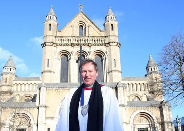 The Very Rev John Mann leaves St Annes Cathedral at Easter