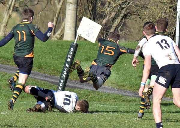 Down's William Annett flies in to score
during the Schools Cup match against MCB.
