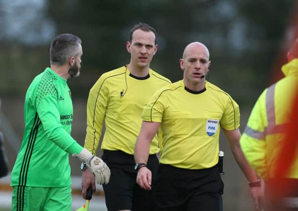 Armagh keeper John Connolly confronts referee Arnold Hunter after the controversial opening goal at Holm Park