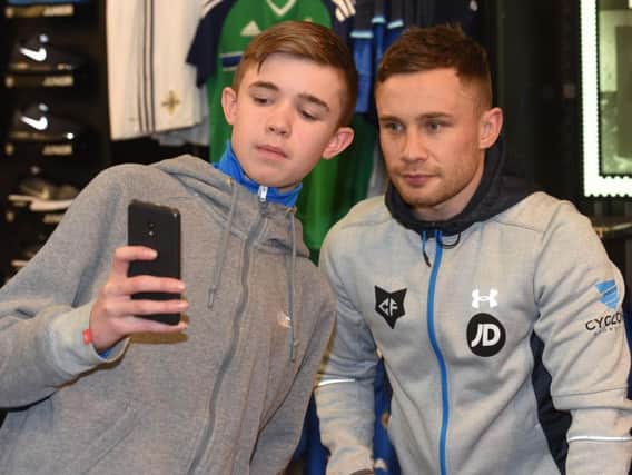 Boxer Carl Frampton poses for a selfie with a young fan in Belfast