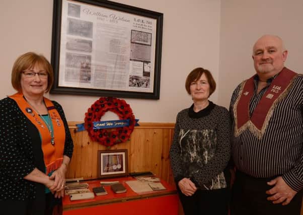 Florence Graham, Sandra Malcomson, and Sammy Wilson at the memorial dedicated to their late father, William Wilson, recently unveiled in Curley Orange hall