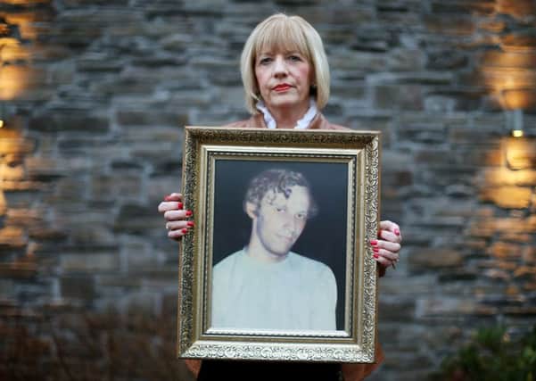 File photo dated 02/01/16 of Karen Armstrong holds a photograph of her brother John McConville who was killed in the Kingsmill attack. Mrs Armstrong has appealed to his killers to search their conscience and give answers to the long-delayed inquest
