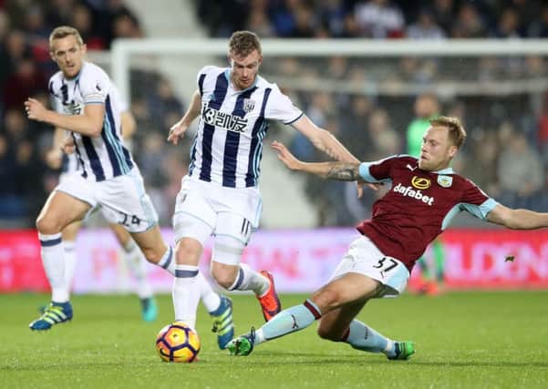 West Bromwich Albion's Chris Brunt (centre) is tackled by Burnley's Scott Arfield