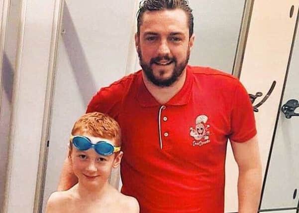 Eight-year-old Lucas McKeown and his swim instructor Paul Murphy