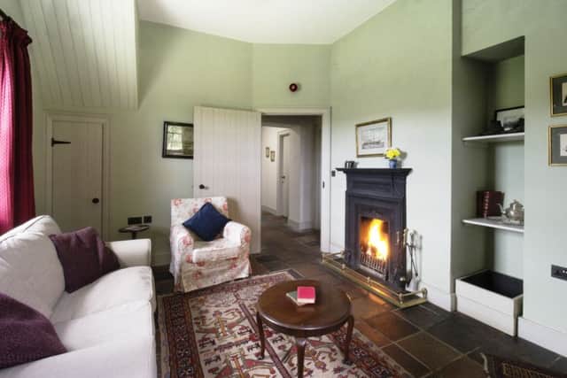 The cosy living room with open fire at the Magherintemple Gate Lodge