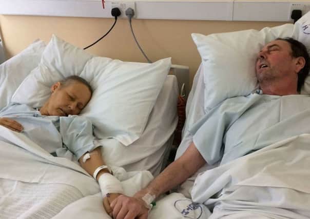 Undated family handout photo of terminally ill Julie Bennet, 50, and husband Mike, 57, pictured together days before they both died, as donations have flooded in for their three children who shared the picture of their parents holding hands on their deathbeds