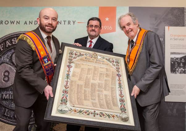 Dr Chris McGimpsey (right) and Chris Thackaberry from Dublin and Wicklow LOL 1313 present the roll of honour to Museum of Orange Heritage curator, Dr Jonathan Mattison (centre)