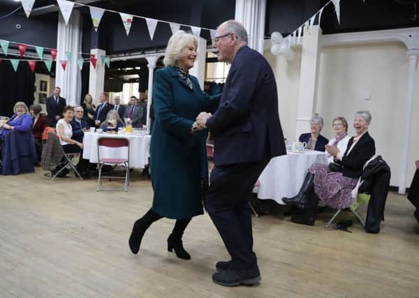 The Duchess of Cornwall, President of the Royal Voluntary Service, dances with The Sun royal photographer Arthur Edwards at a tea party and swing dance at The Trinity Centre in Bristol