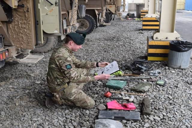 A soldier from 2 Platoon makes sure they have got their tools ready for any vehicle related incident