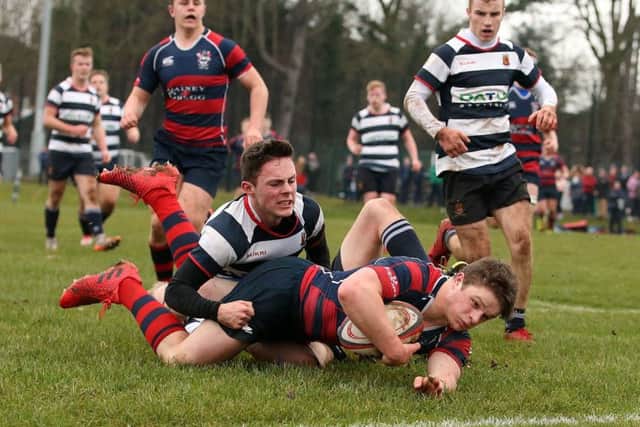 Angus Kernohan  scores his first  try against  Wallace High School