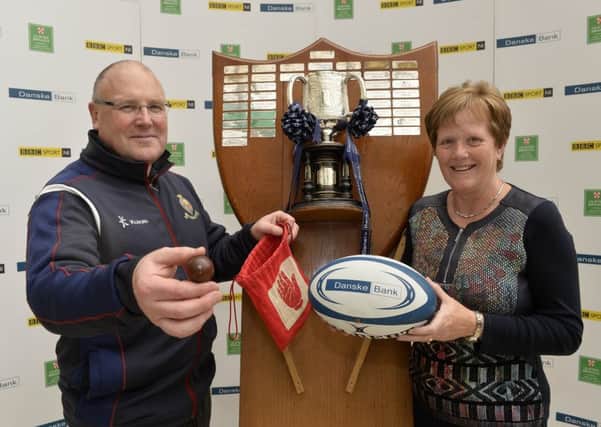 Danske Bank's Valerie Gordon pictured with Royal Schools vice principal Kenny Hooks
 making the draws for the Schools' Cup competitions