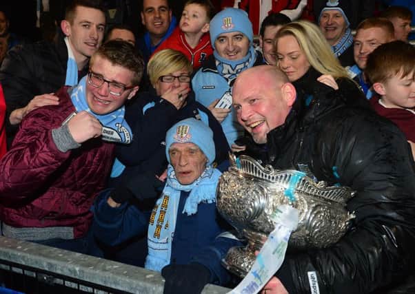Manager David Jeffrey (right) has dedicated Ballymena United's first League Cup triumph in club history to long-serving supporter Trevor Burns. Trevor has missed only a few games in almost six decades as a Sky Blues fan and, despite illness, managed to join his family at Seaview to cheer his beloved club to the landmark 2-0 victory against Carrick Rangers. Pic by Pacemaker Ltd.INBT08-100