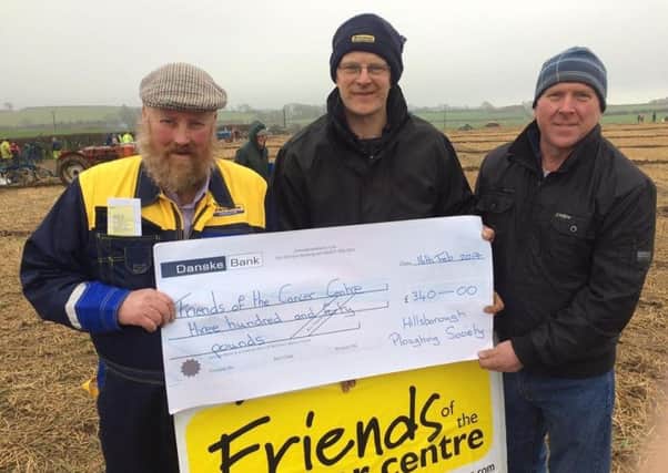 Mercer Ward (left) and James Coulter (centre) from Hillsborough Ploughing Society to Listooder secretary, Wilfie Gill for Â£340 in support of Friends of the Cancer Centre