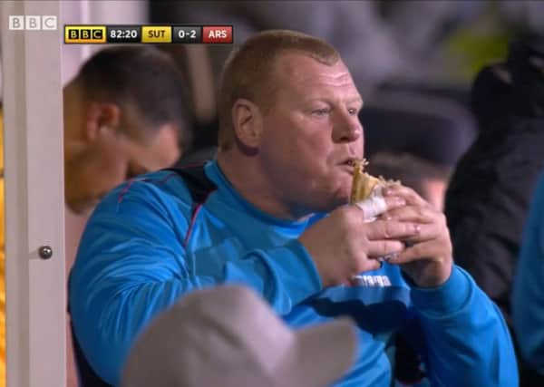 Screen Grab of Sutton's reserve goalkeeper Wayne Shaw eating a pie on the touchline during the Emirates FA Cup, Fifth Round match at Gander Green Lane, London. PRESS ASSOCIATION Photo.