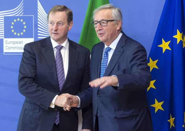 European Commission President Jean-Claude Juncker, right, speaks with Irish Prime Minister Enda Kenny at EU headquarters in Brussels on Thursday