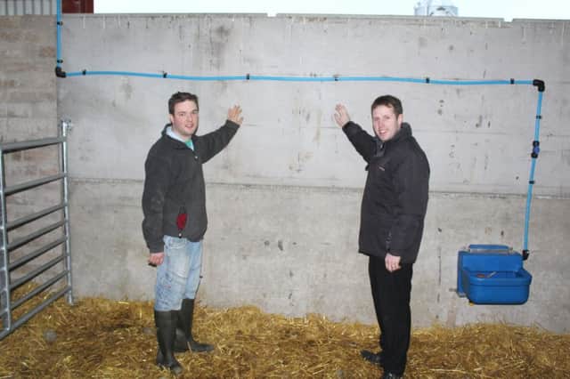 Ballymena Texel breeder Andrew Kennedy (left) discussing the wall panels used in his new sheep unit with Moore Concrete's Jeff Haslett
