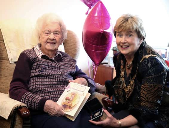 Isobel Foster, pictured on her 104th birthday,  enjoys a visit from the Mayor of Causeway Coast and Glens Borough Council, Alderman Maura Hickey, to mark the very special occasion. The Mayor is holding a medal sent as a birthday gift to Isobel from the President of Ireland.PICTURE KEVIN MCAULEY/MCAULEY MULTIMEDIA