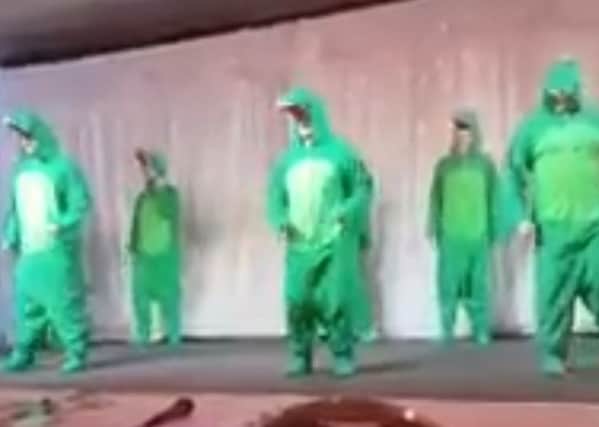 A still from Twitter video posted by SFs Eoin McShane showing members dressed as crocodiles. It is seen as a comeback to DUP Irish language comments