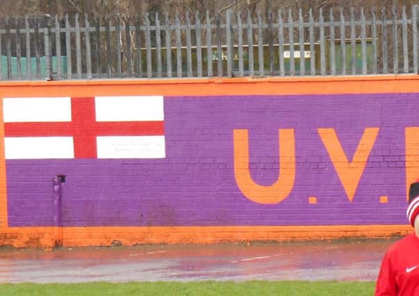 The UVF mural is visible behind the East Belfast FC youth players