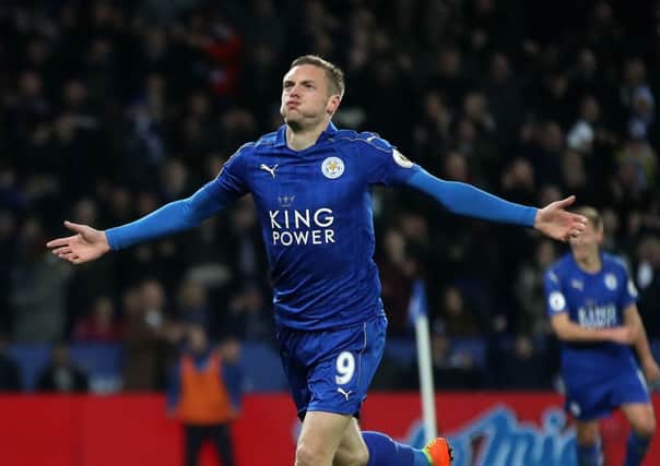 Leicester City's Jamie Vardy wheels away in celebration after scoring his side's third goal against Liverpool