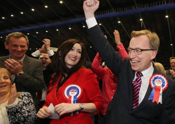 Richard Pengelly (left) applauds after the election to the Assembly of his wife Emma Little Pengelly and Christopher Stalford on May 7 last year